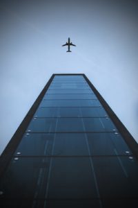 Airplane and building, low angle